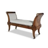 A MAHOGANY AND BRASS MOUNTED EMPIRE WINDOW SEAT, the outscrolled arms inset with brass paterae,