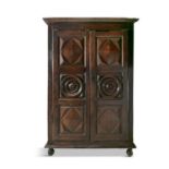 A LATE 17TH CENTURY FRUITWOOD ARMOIRE, with moulded cornice, above twin doors carved with roundels,