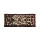 A PERSIAN WOOL RUNNER, the blue ground decorated with a geometric field pattern, within red and