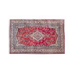 A FINE PERSIAN RED GROUND WOOL RUG, 20th century, the rectangular ground with central lozenge,