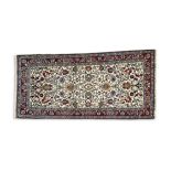 A HEREKE CREAM GROUND RUNNER, the central field profusely decorated with floral and foliate design