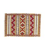 A MOROCCAN CARPET, the central reserve woven with alternating bands of geometric decoration, in red,