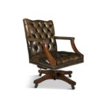 A CLOSE NAIL BUTTON BACK SWIVEL CHAIR, the square back, seat and arms upholstered in green leather,