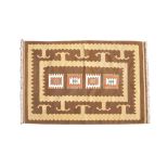 A KONYA TURKISH WOOL RUG, in camel and dark brown tones, with four central geometric motifs in red,