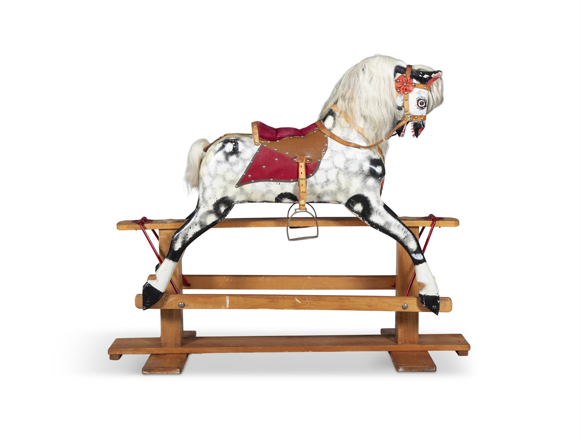 A 19TH CENTURY PAINTED TIMBER ROCKING HORSE, on a hinged swing support with pendulum movement,