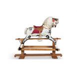 A 19TH CENTURY PAINTED TIMBER ROCKING HORSE, on a hinged swing support with pendulum movement,