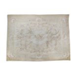 AN AUBUSSON PATTERN WOOL RUG, the cream ground decorated with a central floral medallion and with