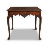 AN IRISH MAHOGANY TEA TABLE, MID 18th Century, the moulded rectangular top above a shaped frieze