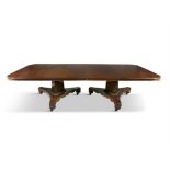 A GEORGE IV MAHOGANY DINING TABLE, of rectangular form with moulded rim, raised on two triangular