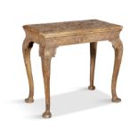 A GEORGE II STYLE GILTWOOD AND GESSO SIDE TABLE, the top carved in low relief foliage sprays,
