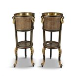 A PAIR OF EMPIRE STYLE EBONISED AND PARCEL GILT BERGERE JARDINERES, each having caned planters