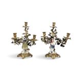 A PAIR OF GILDED METAL AND PORCELAIN FIGURAL CANDELABRA, French 19th Century, in the rococo taste,
