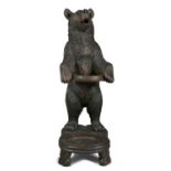 A SWISS 'BLACK FOREST' LINDEN WOOD BEAR STICK STAND, 19TH CENTURY, on the form of a standing