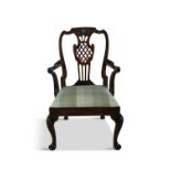 A GEORGE II MAHOGANY OPEN ARMCHAIR, MID-18TH CENTURY, probably Irish, with a relief carved shell