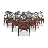 A SET OF TEN MAHOGANY FRAMED 'HEPPLEWHITE' OPEN ARMCHAIRS, C.1900, with carved open oval backs