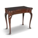 AN IRISH GEORGE III MAHOGANY FOLDING TOP CARD TABLE, of shaped rectangular form with outset