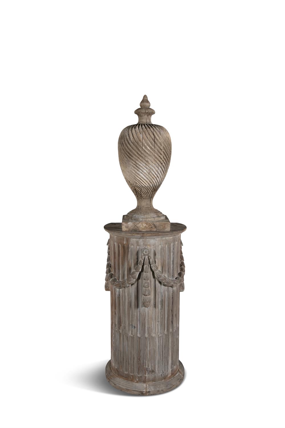 A 19TH CENTURY CARVED PINE PEDESTAL, of demi-lune shape, with stop-fluting and classical swags,