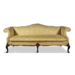 A GEORGIAN STYLE MAHOGANY FRAMED SERPENTINE-BACK UPHOLSTERED THREE SEATER SOFA with scroll