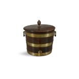 A GEORGE III MAHOGANY BRASS BOUND CIRCULAR CISTERN, the lid with pineapple finish,