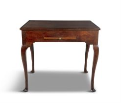 AN IRISH MAHOGANY GAMES TABLE C. 1740, the reversible moulded top with mahogany counter holders,