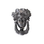 A STEEL DOOR KNOCKER IN THE FORM OF THE HEAD OF MERCURY. 20cm high