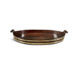 AN OVAL MAHOGANY BRASS BOUND BUTLER'S TRAY, EARLY 19TH CENTURY, with out-turned handles. 58 x 36cm