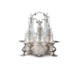 A GEORGE II IRISH SILVER WARWICK CRUET STAND, C.1750, the typical frame fitted with three castors,