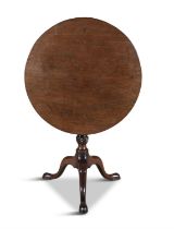 A GEORGE III MAHOGANY CIRCULAR SUPPER TABLE, the revolving plain top on a bird-cage action and