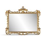 AN EDWARDIAN CHIPPENDALE STYLE CARVED GILTWOOD WALL MIRROR, the bevelled rectangular mirror plate