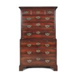 A GEORGE III MAHOGANY CHEST ON CHEST, 18th century, the moulded straight pediment above three