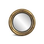 A VICTORIAN GILTWOOD CIRCULAR CONVEX MIRROR, the tubular frame with leaf carved collars.