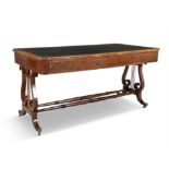 A REGENCY PARTRIDGE WOOD AND BRASS MOUNTED LIBRARY TABLE, the shaped rectangular top inset with