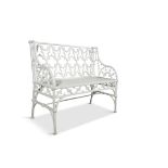 A PAIR OF VICTORIAN CAST IRON TWO SEAT GARDEN CHAIRS, in the gothic taste with open tracery and