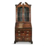 A RARE GEORGE II STAINED WOOD BUREAU BOOKCASE, probably walnut, the arched top with broken swan