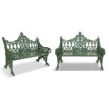 A PAIR OF EARLY 20TH CENTURY CAST IRON GREEN PAINTED GARDEN BENCHES, the open gallery backs with