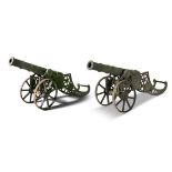 A PAIR OF 19TH CENTURY CAST IRON SIGNAL CANNONS, each on two wheel carriages. 155cm long,
