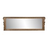 A GEORGE III GILTWOOD FLAT CARVED OVERMANTLE MIRROR, the rectangular plate contained within a