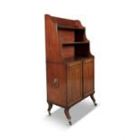 A GEORGE IV MAHOGANY COMPACT BOOKCASE, stamped Gillows, the three-tiered shelf top above a