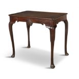 A GEORGE III MAHOGANY SILVER TABLE, the rectangular top above a shaped apron centred with a