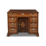 A 19TH CENTURY INLAID MAHOGANY KNEEHOLE DESK, later inlaid, with central long frieze drawers on