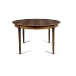 DINING TABLE A rosewood circular extending dining table, with two leaves. Denmark c.1960.