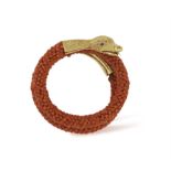 A CORAL AND GOLD SNAKE BRACELET The coiled serpent with coral beads for body, the head and tail