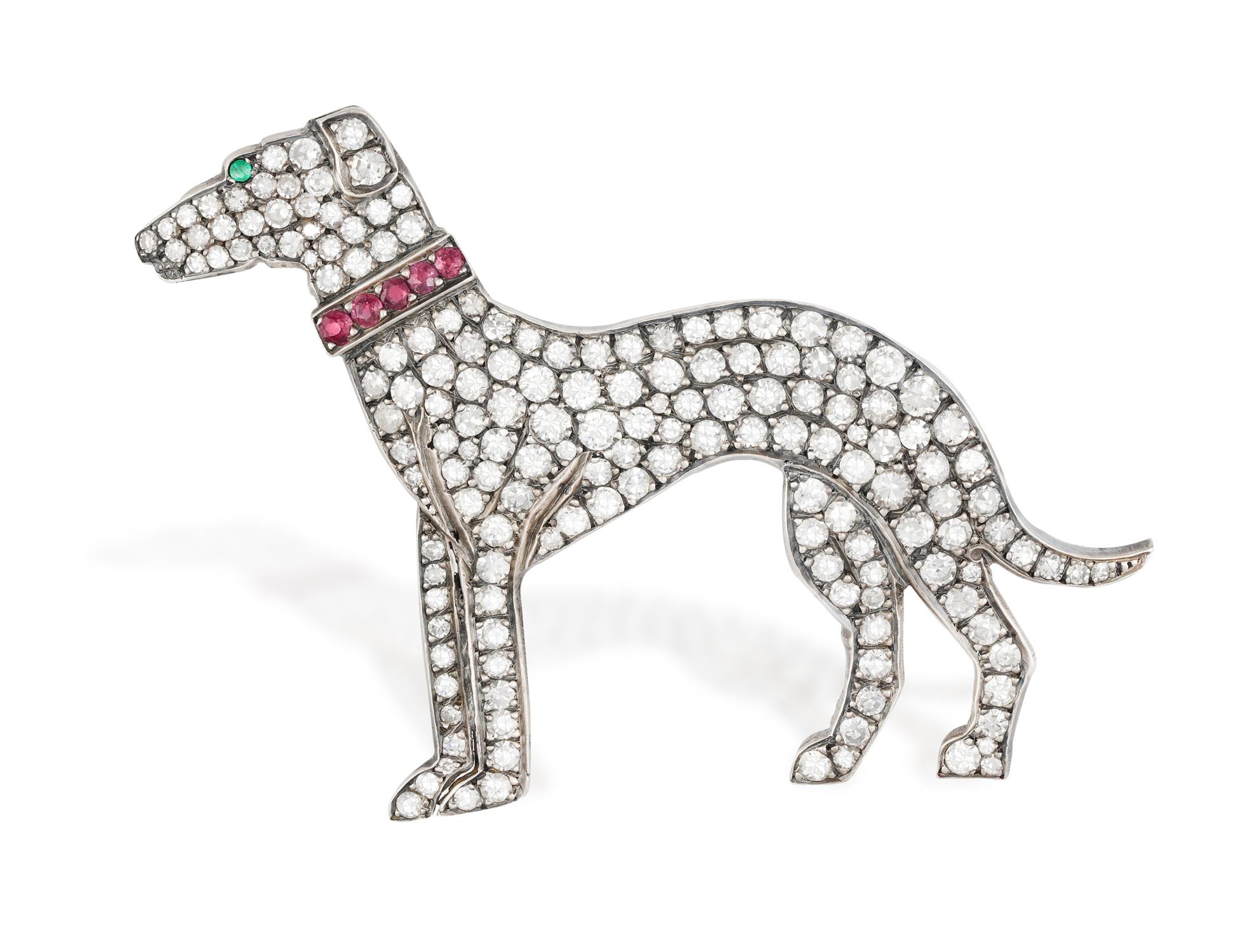 A DIAMOND, RUBY AND EMERALD NOVELTY BROOCH The stylised greyhound set throughout with single-cut
