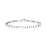 A DIAMOND LINE BRACELET Composed of a continuous row of brilliant-cut diamonds within