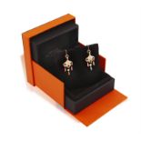 A PAIR OF DIAMOND 'FILET D'OR' PENDENT EARRINGS, BY HERMÈS Each bombé plaque suspending three