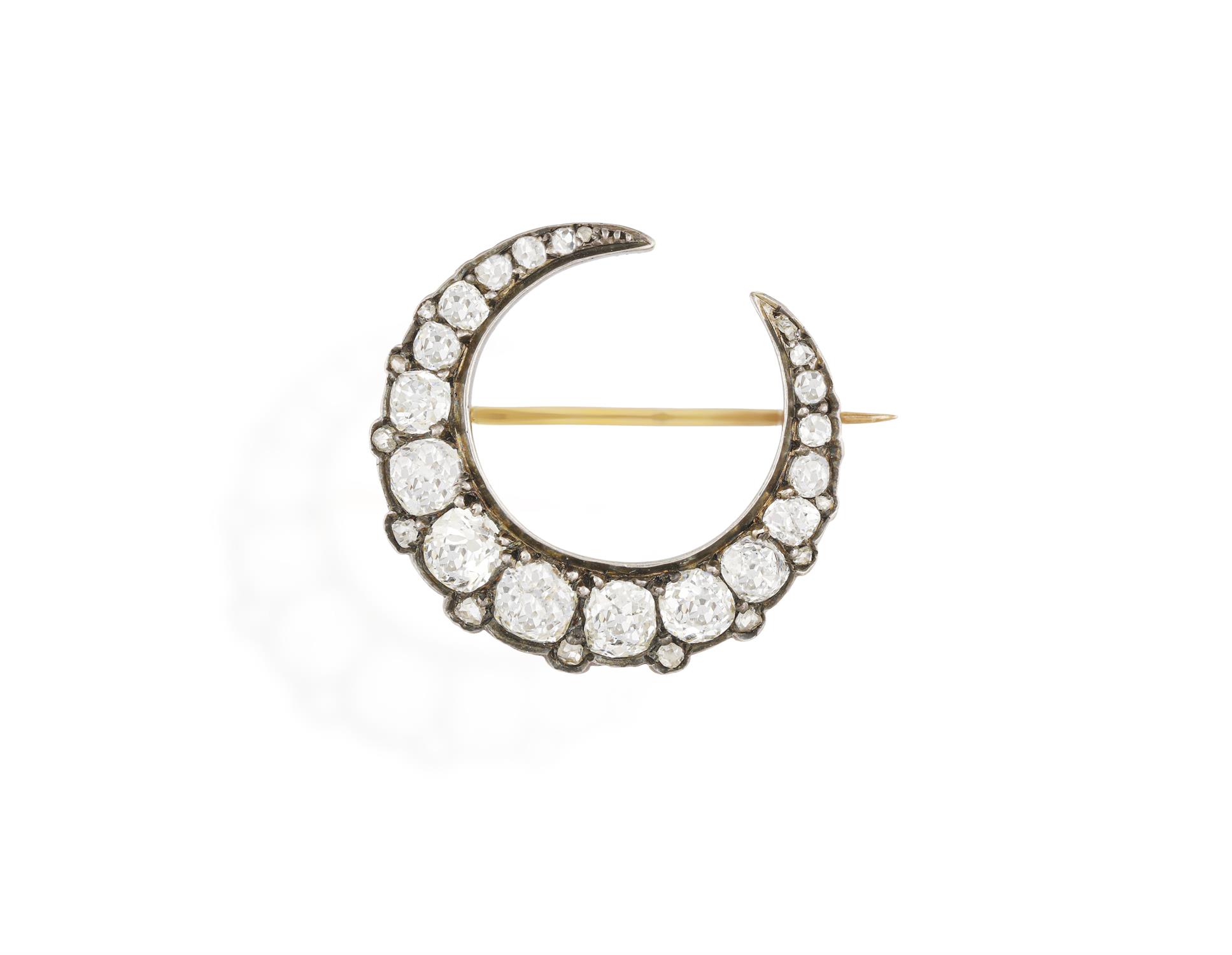 A LATE 19TH CENTURY DIAMOND BROOCH, CIRCA 1880 Of crescent design set with old cushion-shaped