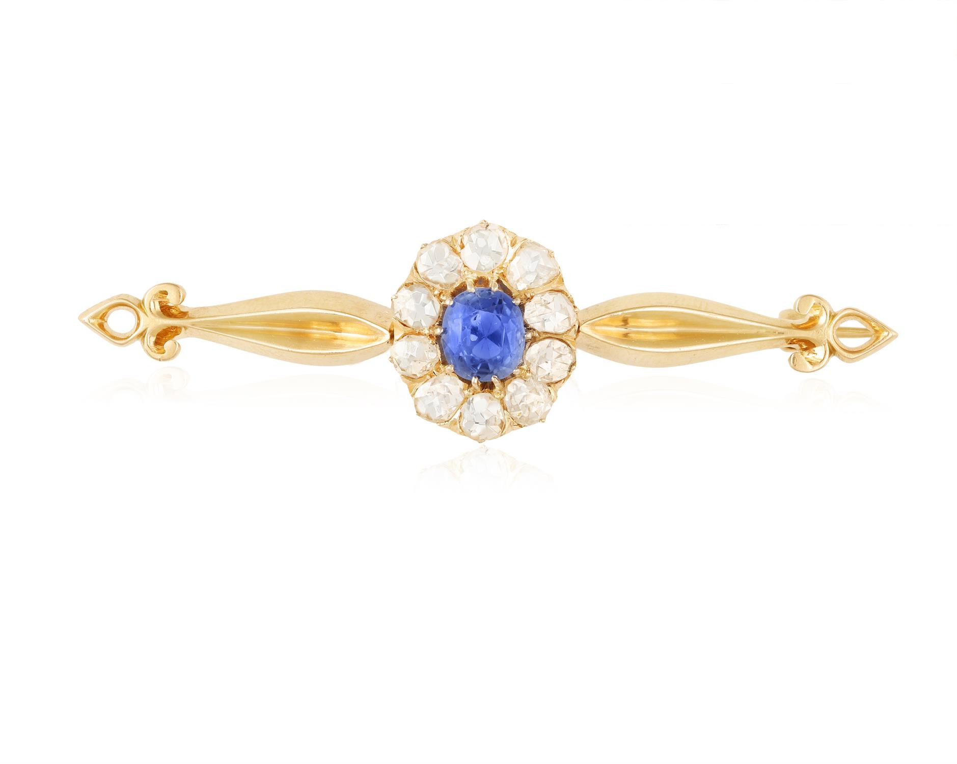 A SAPPHIRE AND DIAMOND BROOCH The oval-shaped sapphire within a rose-cut diamond frame between