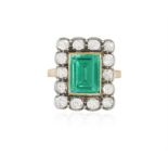 A FINE EMERALD AND DIAMOND DRESS RING, CIRCA 1900 The rectangular emerald weighing approximately