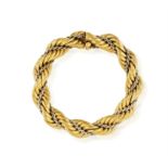 A TWO-TONE GOLD BRACELET, ITALIAN, 1970 Designed as twisted gold ropework with a wrap around