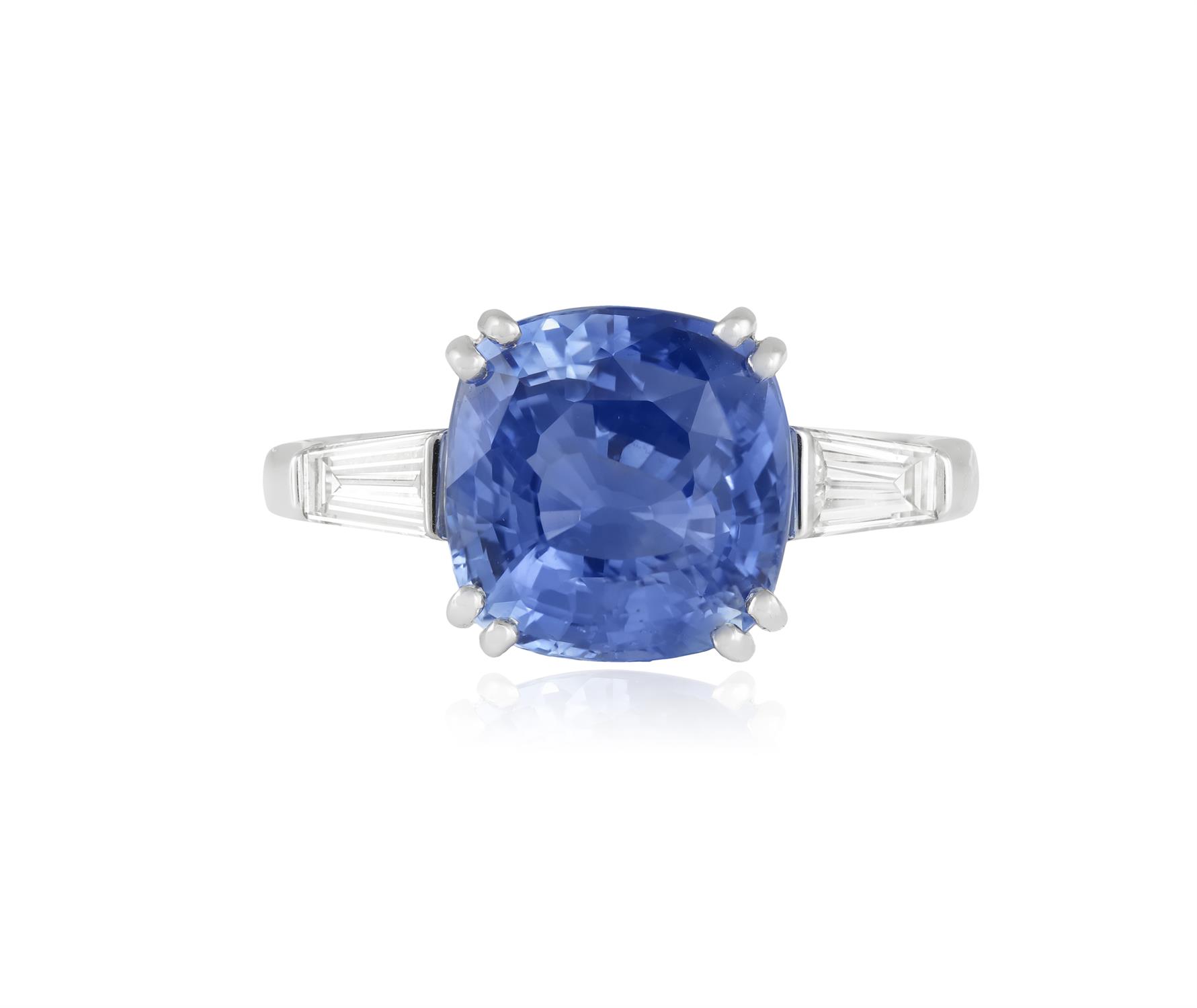 A SAPPHIRE AND DIAMOND DRESS RING The cushion-shaped sapphire weighing approximately 5.